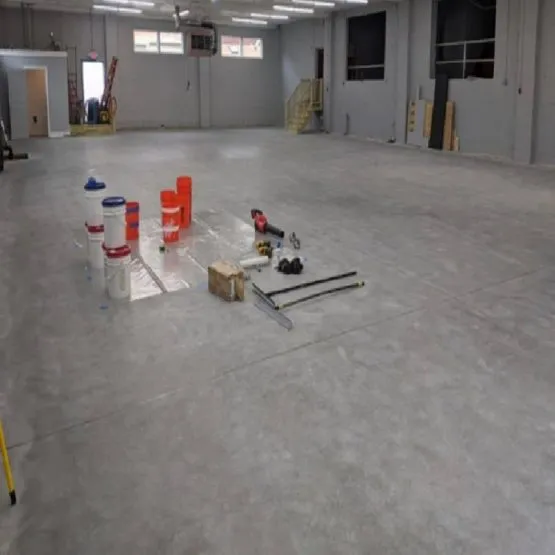 Empty warehouse with tools and buckets on floor