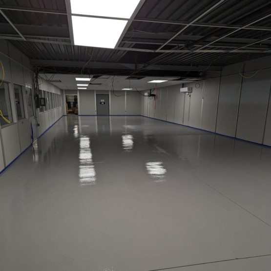 Empty industrial room with glossy epoxy floor