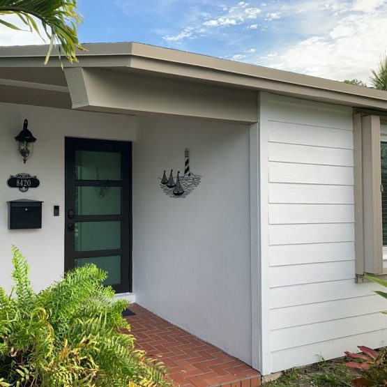 Modern white house entrance with glass door