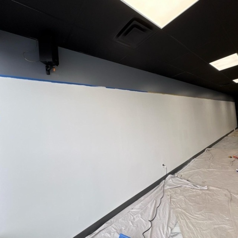 Freshly painted white wall with protective floor covering