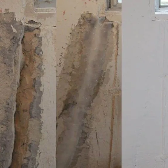 Damaged interior wall with peeling plaster and water stains